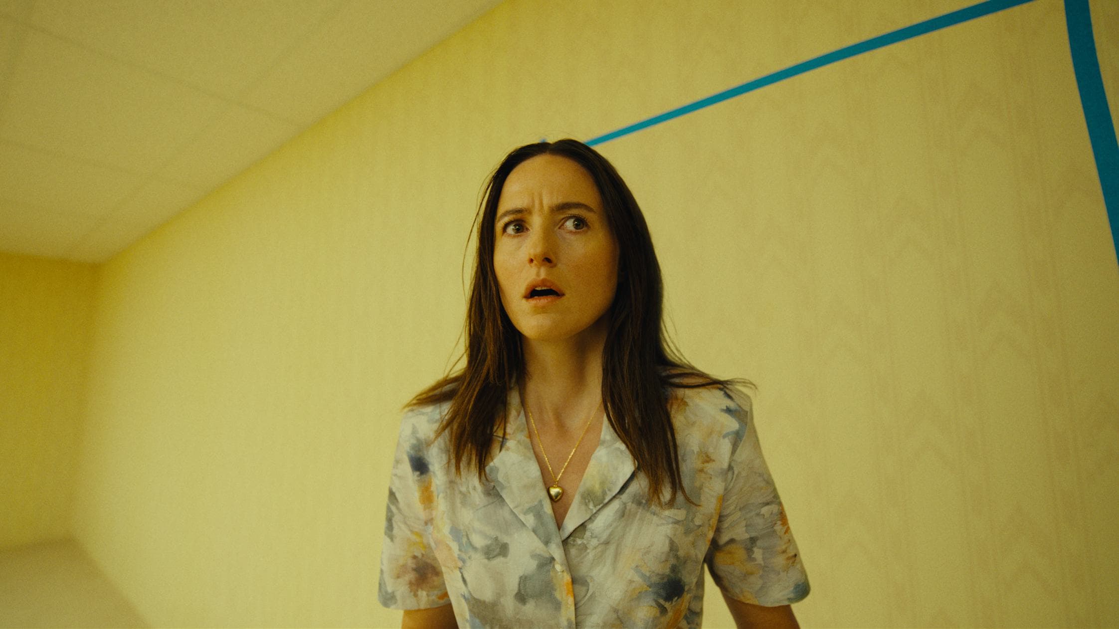 Promotional image for Backrooms showing an unsettling retail basement passage.