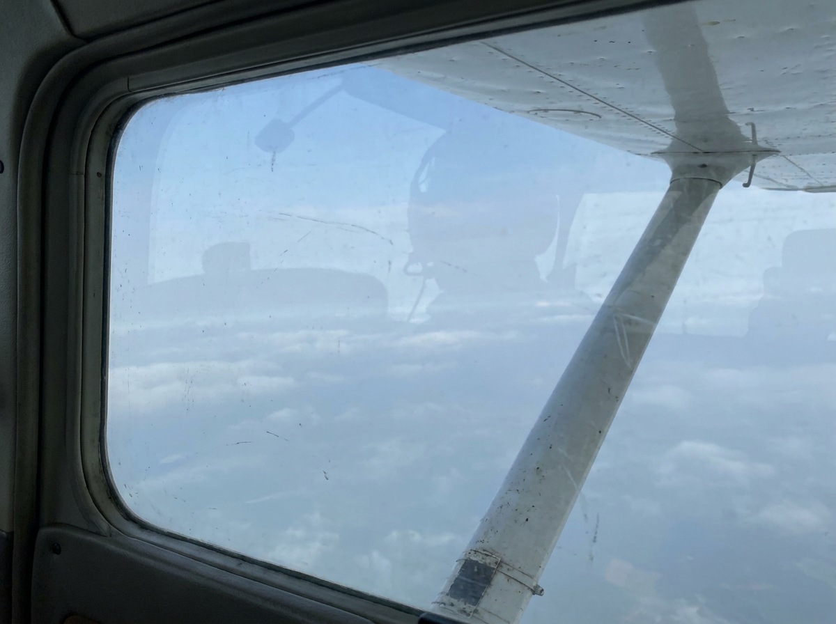 Pale blue sky and cloud layer from altitude.