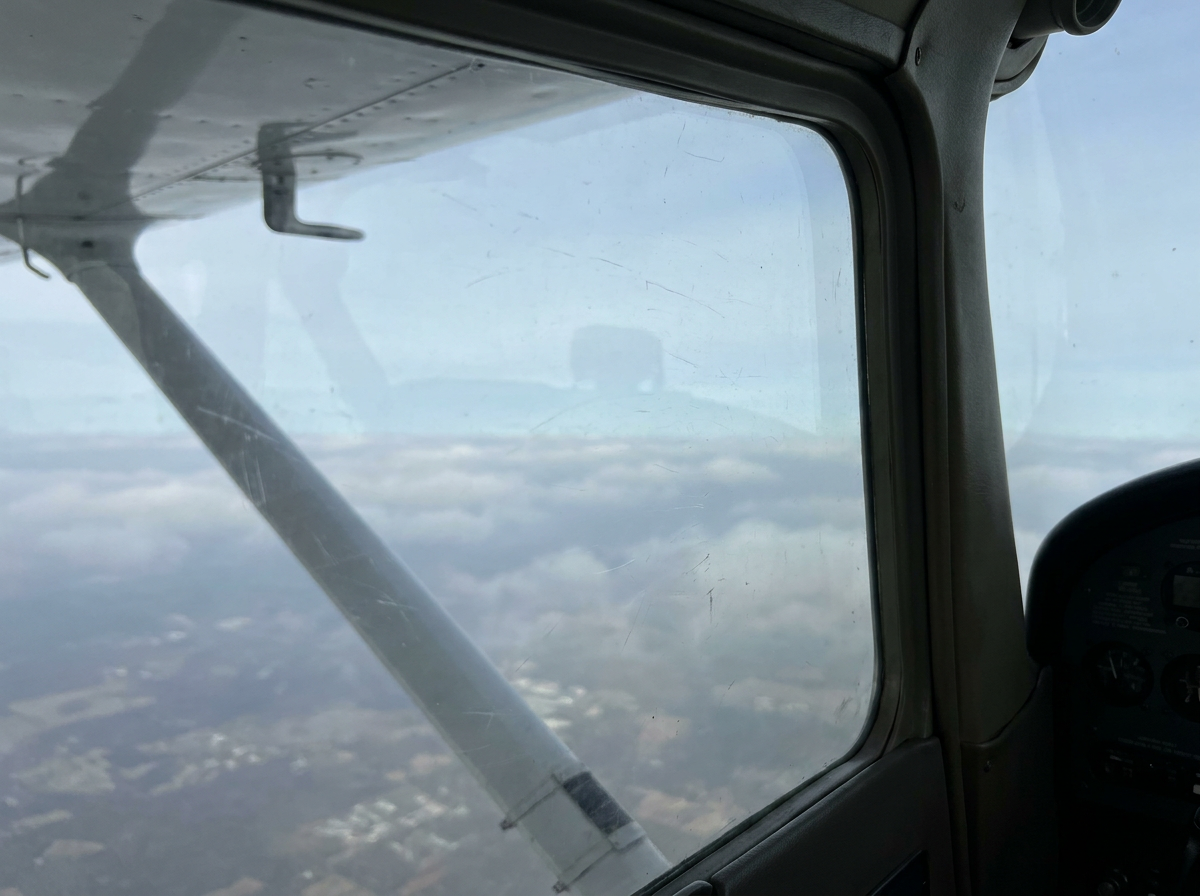 Bright sky with soft clouds seen from high altitude.