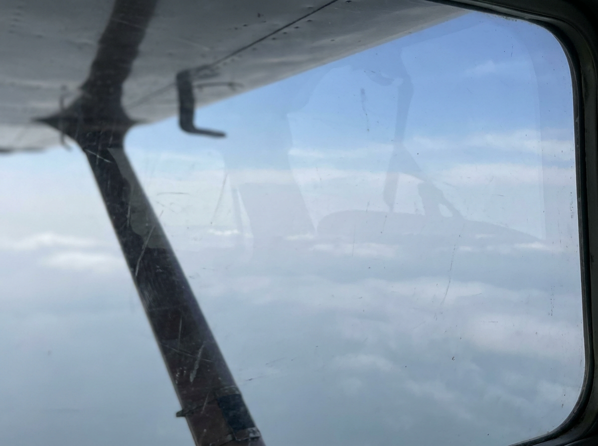 Pale sky and wing reference from altitude.