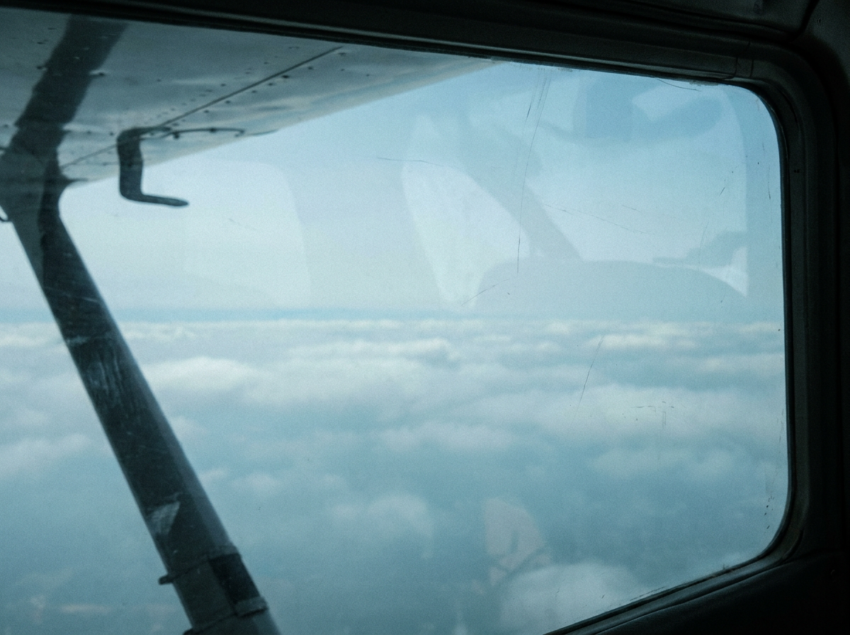 Another pale sky image with clouds from altitude.